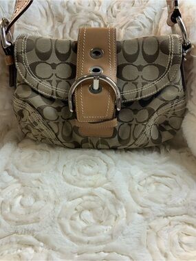 vintage Coach Soho Signature Hobo Bag featuring the brand's iconic monogram